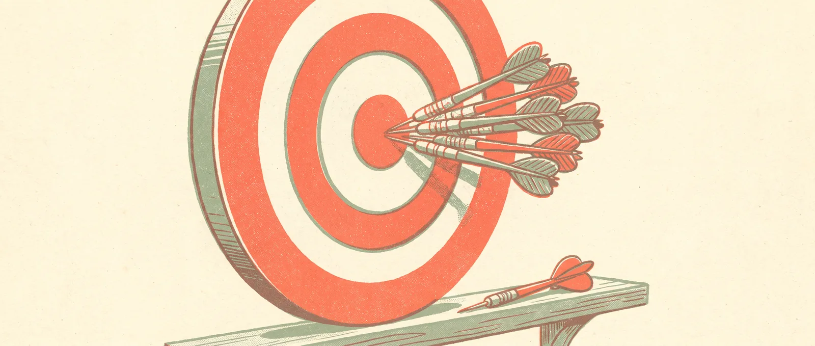 A dartboard bristling with thrown darts while a single dart lies untouched on the shelf below