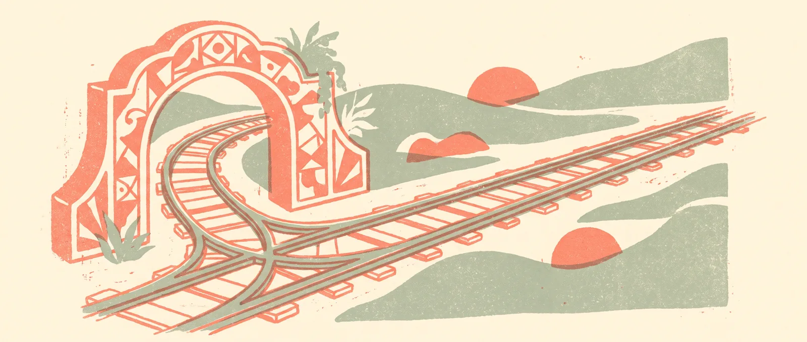 Two railway tracks parting at a switch, one passing through an ornamental gateway arch